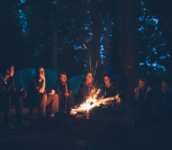 People sitting around a campfire