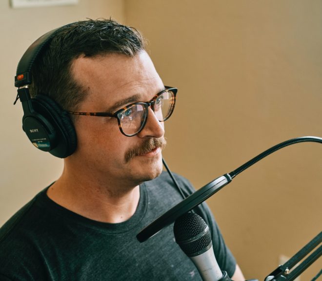 Man wearing headphones and speaking into microphone